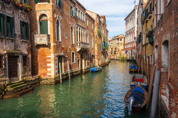 Fototapeta premium Traditional narrow romantic canal with old houses in Venice, Italy