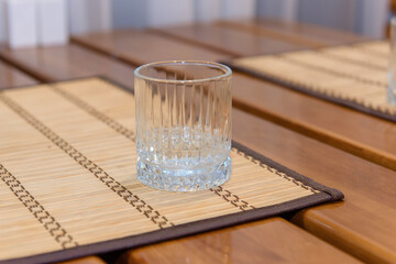 An empty glass on the table. Glass tableware for drinking.