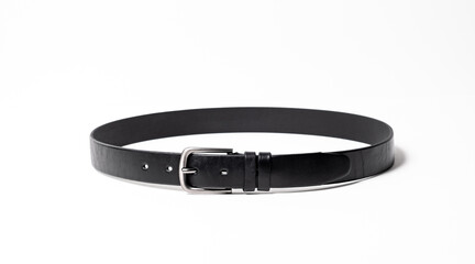 Black Classical leather Belt isolated on white background close-up. Fastened fashionable unisex accessory with dark chrome matted metal buckle. Man lux strap. Haberdashery goods. Minimalistic style.