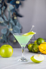 Refreshing green apple cocktail garnished with fruit slices