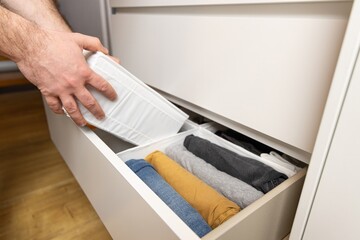 KonMari Method. The photo illustrates a popular method of storing clothes, where items are placed...