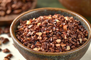 Fototapeta premium Close-Up of Chopped Cocoa Nibs in Rustic Bowl on Table Surface