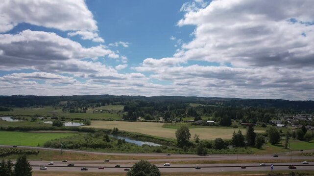 Drone timelapse of Interstate 5 with car traffic during the day and cloudy sky in Centralia, Washington, USA