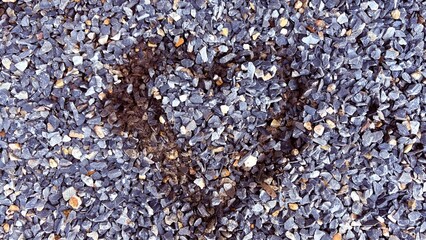 Close up gravel texture has heart shape in the center.