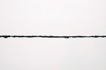 Line of texture revealing a black painted surface against a white wall background