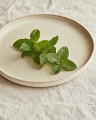 Fresh mint leaves in a bowl on a wooden table
