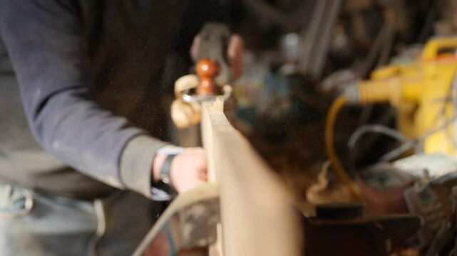 Artisan Working with a Hand Plane, Planing an Iroko Plank Close-Up