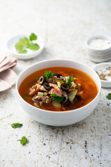 Meat soup with gherkins and olives