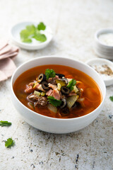 Meat soup with gherkins and olives