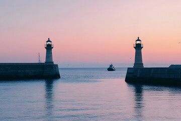 Fototapeta premium Twin Lighthouses at Harbor Entrance Overlooking Busy Lane 