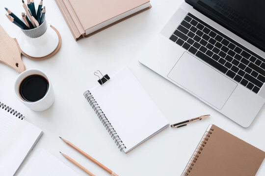 Modern office desk with laptop, coffee and stationery, working from home concept - Powered by Adobe