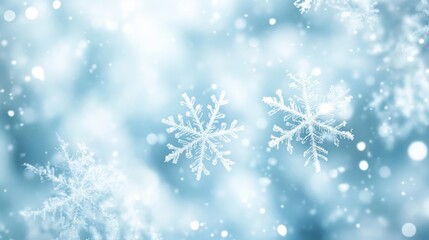 Glistening snowflakes descend against a dreamy blue background, creating a serene winter atmosphere.