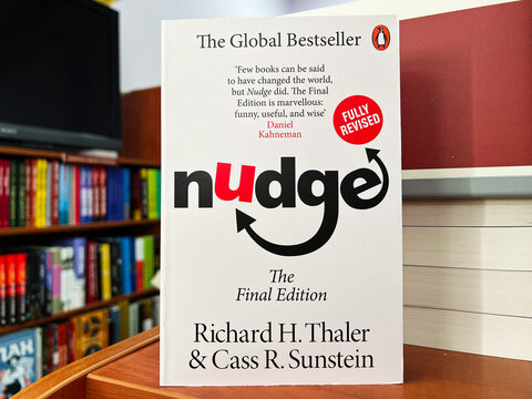 Book Display Featuring Nudge by Richard Thaler and Cass Sunstein on a Bookshelf
