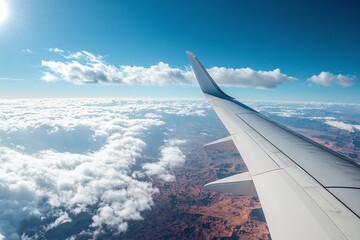 Obraz premium Airplane Wing View with Blue Sky Scenic Landscape and Fluffy Clouds from a Flight Above Earth