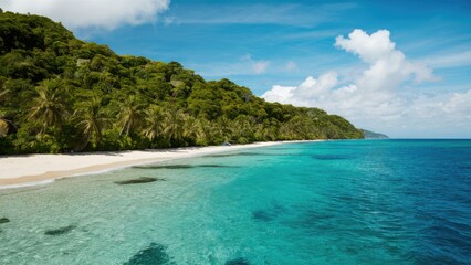 Fototapeta premium Serene tropical shoreline with clear turquoise waters and lush green hills under a bright blue sky dotted with white clouds.