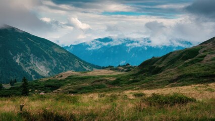 Fototapeta premium Lush green mountain vegetation under a cloudy sky with rolling hills and distant blue mountains in the background creating a serene landscape.