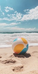 Obraz premium Vibrant Beach Ball on Sandy Shore with Waves and Blue Sky in Summer Coastal Scene for Relaxation