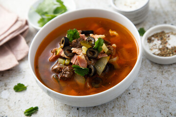 Meat soup with gherkins and olives