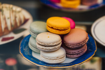 Colorful macarons stacked on a plate. A delightful treat for any sweet tooth! Perfect for food blogs, bakeries, or dessert-themed designs