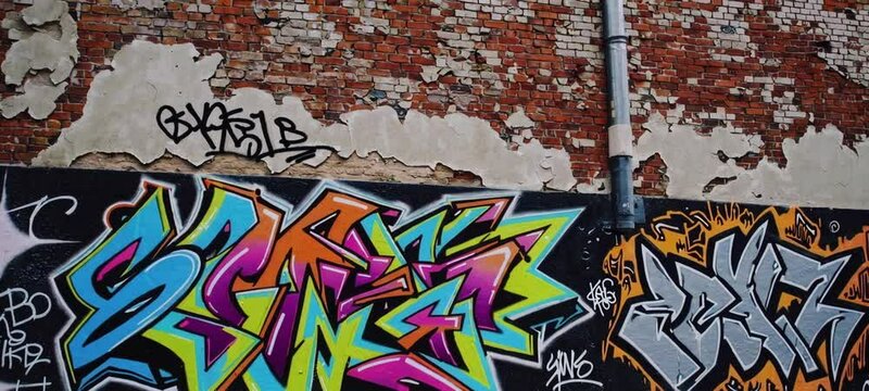 Vibrant urban graffiti on weathered brick wall captures bold street art culture