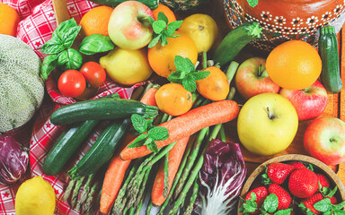 rustic composition of mixed fruits and vegetables viewed from above