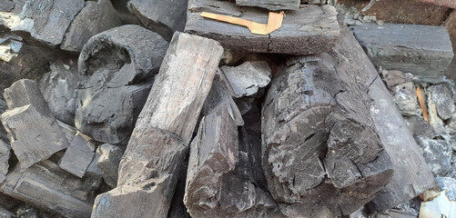 Closeup shot of a pile of charcoal with fire for a barbecue	
