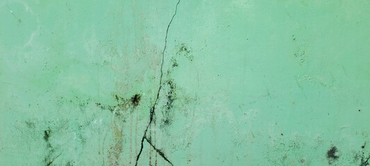 Concrete cement green wall with crack in industrial building	

