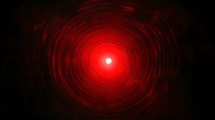 Red circular light glowing in the center of a dark background for design and artistic use