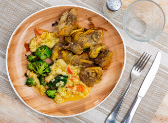 Appetizing fried chicken pieces served on plate with broccoli