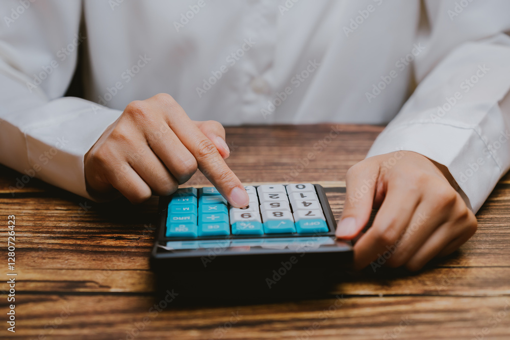 Poster person using calculator with finger on button in office setting