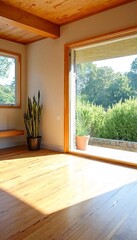 Obraz premium Wooden floors and plants in a room with large windows that offer a view of trees.