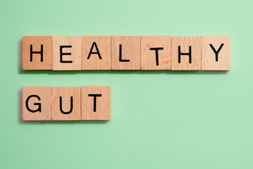 Healthy gut in wooden tiles on green background