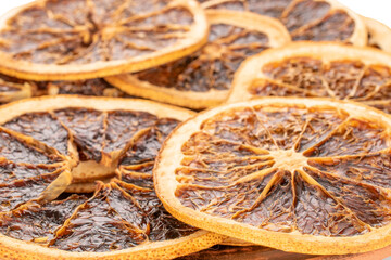 Dried grapefruit slices on a clay plate, macro.