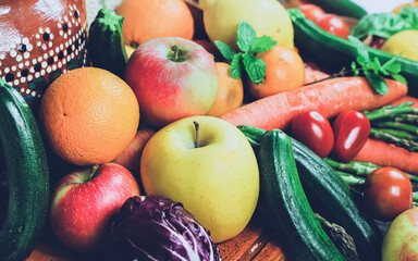 rustic composition of mixed fruits and vegetables viewed from above