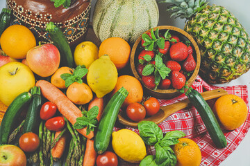 rustic composition of mixed fruits and vegetables viewed from above