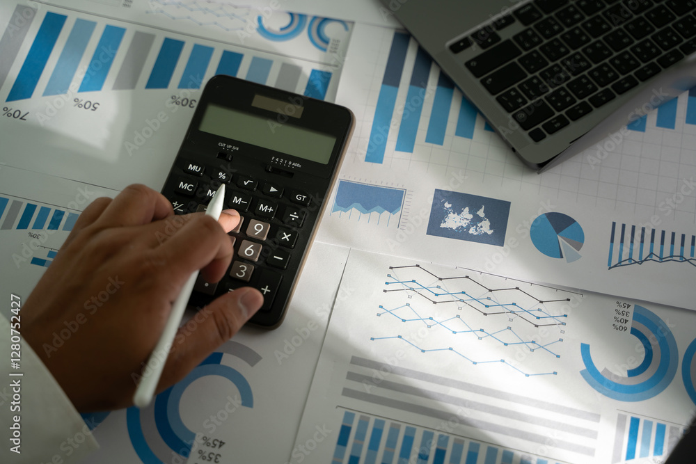 Aufkleber a person is using a calculator financial accounting business read report analysis graph data on pape
