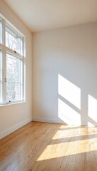 Fototapeta premium A room with white walls and natural light streaming through windows.