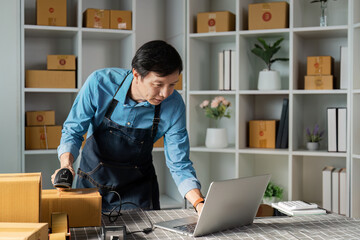 E-commerce entrepreneur scanning products for inventory management in a home office, optimizing online sales processes.