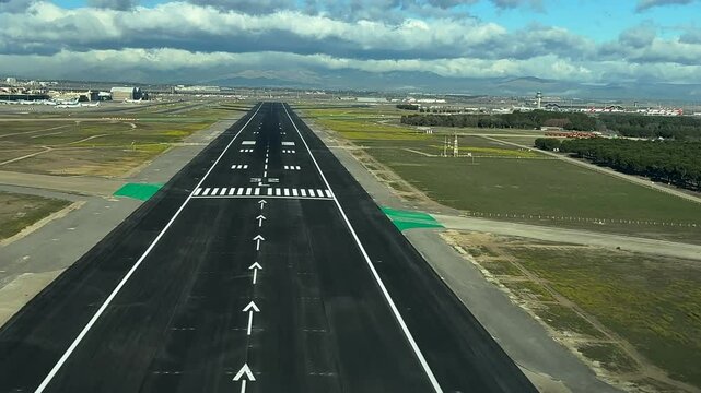 Immersive real time landing through the pilot&rsquo;s eyes from the cockpit of a jet, with a blue sky covered with some stratus clouds. 4K 60FPS