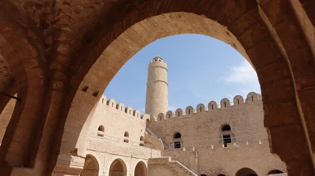 Tunisia history and architecture, abstract shot of tower of Ribat seen through bows, ancient monument in Sousse
