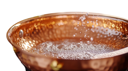 Copper bowl filled with bubbling water in a cozy kitchen setting during a sunny afternoon