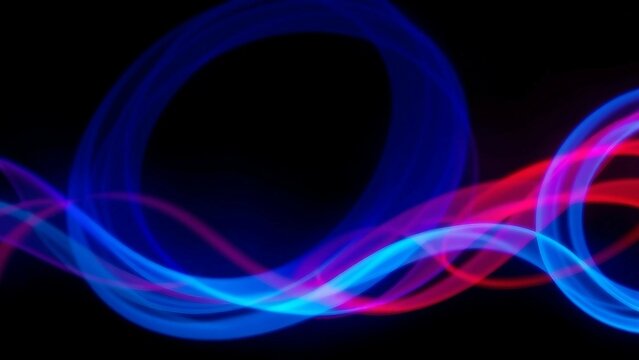 Vibrant dynamic light trails of blue and red flow smoothly across a black backdrop creating an abstr