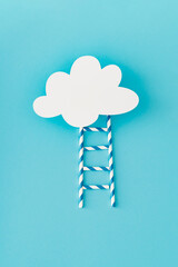Step ladder made of paper drinking straws leading to cloud made of white paper card note on light pastel blue background. Minimal growth, future, development concept. Flat lay, top view banner.