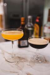 Homemade Margaritas and Espresso Martini on Marble Counter with Bottles in Background