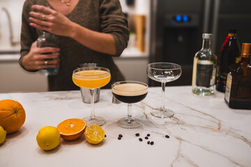 Homemade Cocktails Including Margaritas and Espresso Martini with Fresh Citrus on Marble Counter