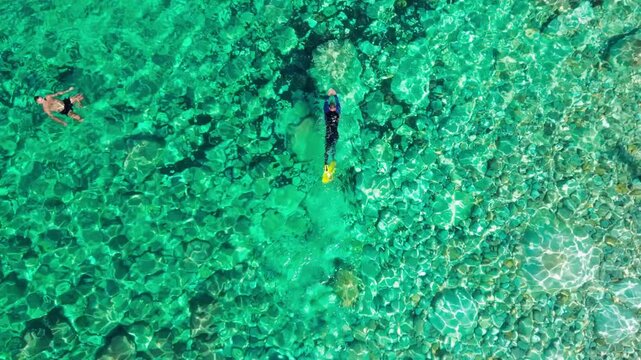 Single man snorkeling in the idyllic turquoise waters of Ibiza, Balearic Islands