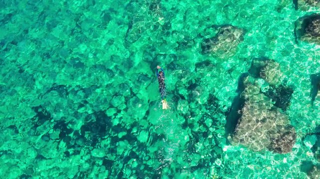 Single man snorkeling in the idyllic turquoise waters of Ibiza, Balearic Islands
