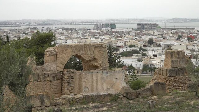 Ancient ruins of Carthage on Byrsa hill contrast with modern buildings and houses in Tunisia
