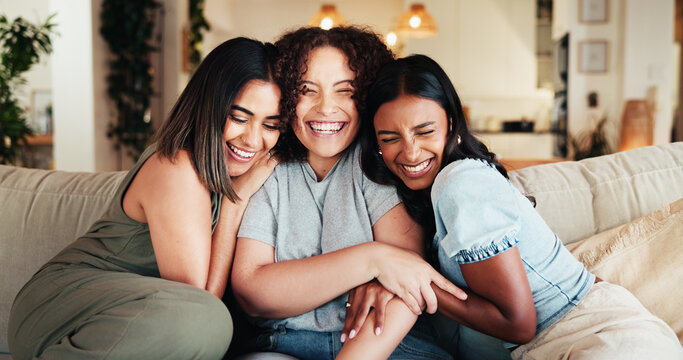Women, friends and hug with smile on sofa for gossip, social bonding or together at home. Female people, group and embrace with love for friendship, friendly advice or chatting on couch at house