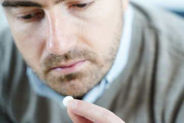 One man close up taking medicine pill treatment